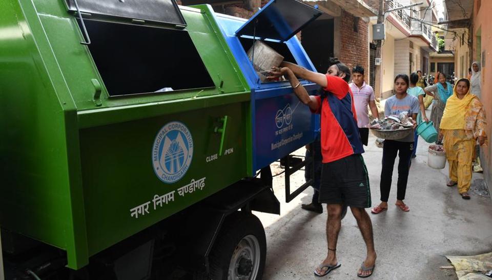Workers sorting recyclable materials on conveyor belt